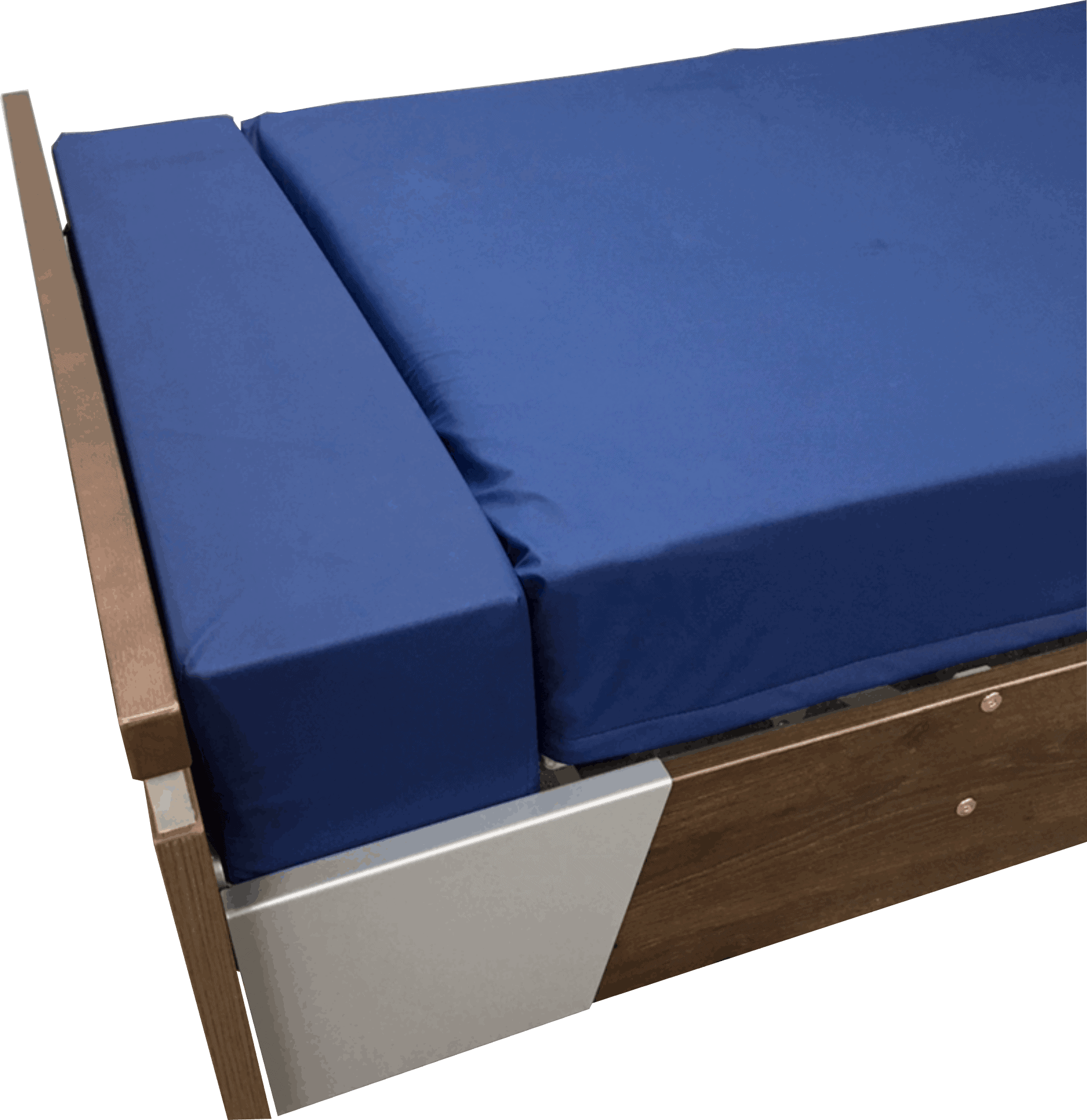 A wooden bed frame with a blue mattress and with mattress extension at the end of the bed. 